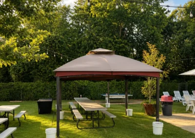 Shaded gazebo party area with picnic tables at Heights Pool, Alamo Heights
