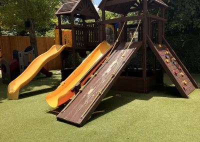 Shaded kids playscape with slides at Heights Pool, Alamo Heights